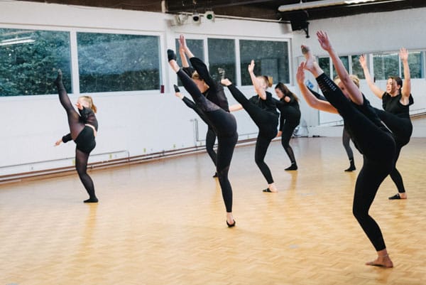 a group of women dancing in a room